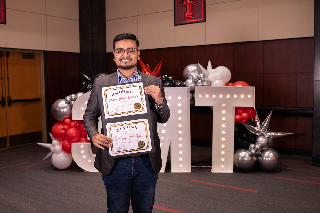 Tahmid Ul Islam holding awards from the 2025 3-Minute Thesis Competition Final Round