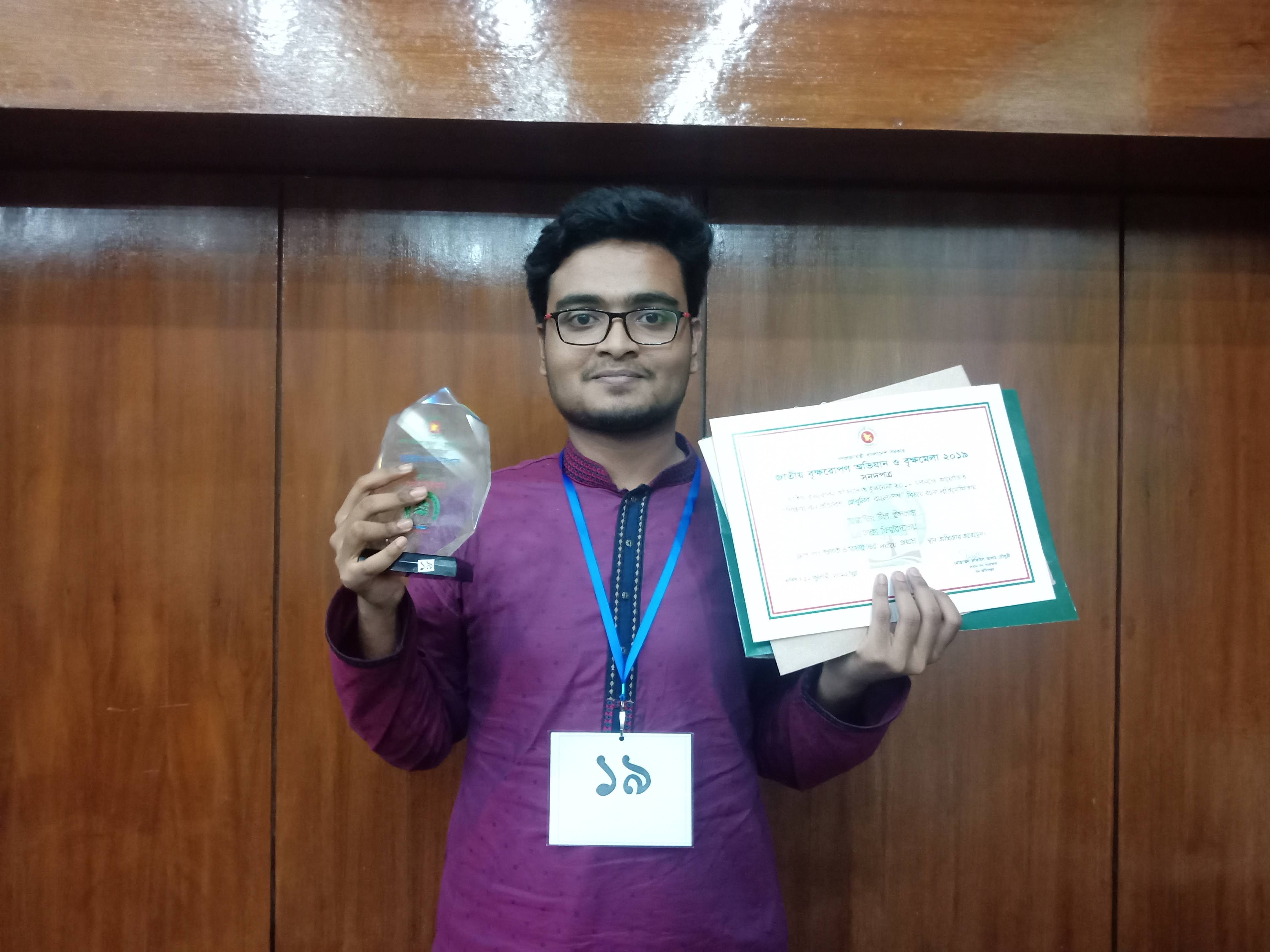 Tahmid Ul Islam with his first-place essay competition award from the Bangladesh Forest Department